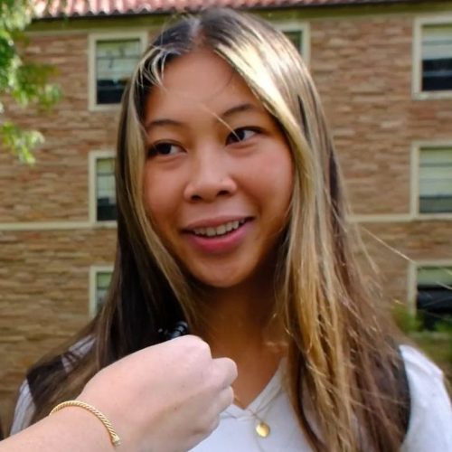 Person with blonde hair and white shirt.